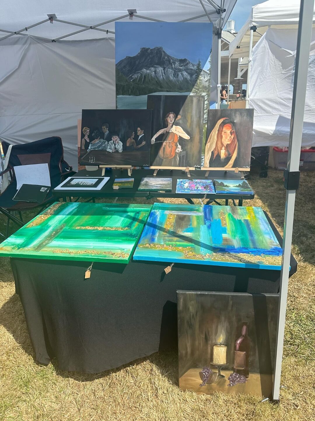 Aniya's paintings on display at an outdoor art festival